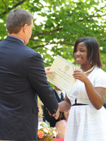 A middle school student receives her diploma at Commencement, 2008.