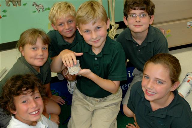 Third grade students become acquainted with Jack, the bearded dragon, in Mrs. Richter's Lower School science class.